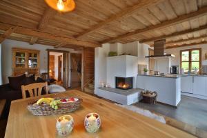 a kitchen and living room with a table and a fireplace at Ferienhaus Hirschkopf in Mauth