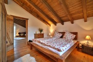 a bedroom with a large bed with red pillows at Ferienhaus Hirschkopf in Mauth