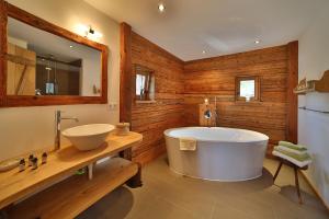 a bathroom with a large tub and a sink at Ferienhaus Hirschkopf in Mauth