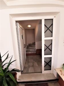 an open door leading to a hallway with stairs at Villa Malena Volos Alykes Beach in Dhimínion