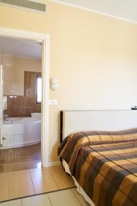 Postel nebo postele na pokoji v ubytování Aparthotel La Pineta