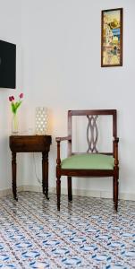 une chaise et une table de chevet dans une pièce dans l'établissement Casa del Duca, à Amalfi