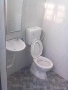 a bathroom with a toilet and a sink at Adilah Homestay B in Pasir Puteh