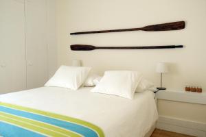 a bedroom with a bed with two baseball bats on the wall at Troia Beach and Nature - Apartment in Troia