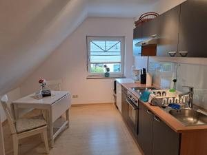 a kitchen with a sink and a counter top at Ferienwohnung am Nordstrand 2 in Alt Schwerin