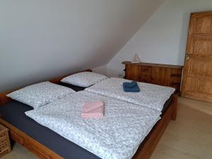 a bedroom with a bed with a pair of shoes on it at Ferienwohnung am Nordstrand 2 in Alt Schwerin