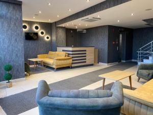 a lobby with two blue couches and a table at Alarga Premier Hotel in Trabzon