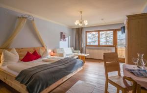 a bedroom with a bed and a living room at Biolandhaus Seethaler in Vorderthiersee