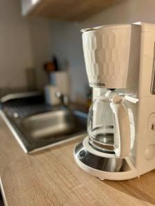 a coffeemaker sitting on a counter next to a sink at Ferienwohnung Viktring 4-5 Pers. in Klagenfurt