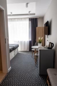 una camera d'albergo con letto e tavolo di Pensjonat Dana a Dziwnów