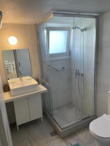 a bathroom with a shower and a sink at Lena's Home in Aegina Town