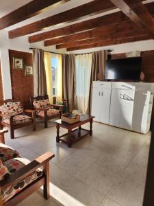 a living room with a couch and a table at Valle Florido 1 in Trevelín