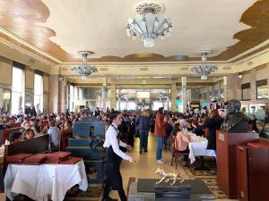 a crowd of people in a large room with tables at Mont-Ventoux, Provence, Appartement avec vue panoramique et piscine in Mollans-sur-Ouvèze