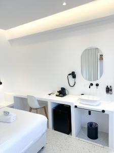 a white desk with a sink and a mirror at Alana Mykonos in Mikonos