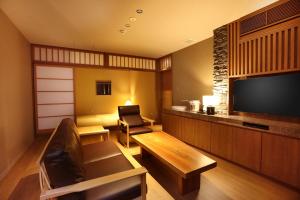 a living room with a couch and a television at yabenomori 
