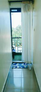 a room with a window and a view of a balcony at EuphGlory accomodations 1 and 2 bedrooms in Kakamega