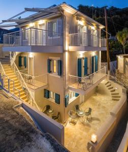 an aerial view of a house with tables and chairs at Pargabella apartments in Parga