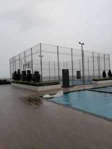a swimming pool in front of a fence at Amber Cove Chillax Homestay Melaka in Melaka