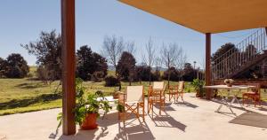a patio with chairs and a table with a view at Hotel Rural Costa del Trigo in Segovia