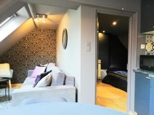 a living room with a couch and a bedroom at L'Escale Glamour et Chic - Netflix, Petit déjeuner français in Niederbronn-les-Bains