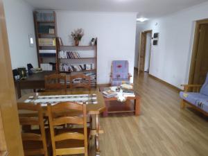 a living room with a table and chairs and a couch at Ático Rosita en Camino de Santiago in Xinzo de Limia