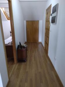 a hallway with a room with a suitcase on the floor at Ático Rosita en Camino de Santiago in Xinzo de Limia