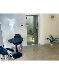 a room with a table and two chairs and a plant at Suite Whiteflower in Bari +25 photos