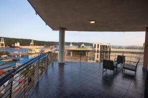 a balcony with chairs and a view of a harbor at Stay at The Point - Arabian Affair in Durban