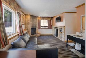 a living room with a couch and a fireplace at Rodeway Inn in Colorado Springs