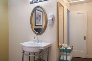 a bathroom with a sink and a mirror at Gilmore Hotel, Trademark Collection by Wyndham in Ketchikan