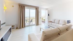 a living room with a couch and a table at Monte Sarago Villas in Ostuni