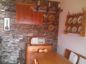 a room with a table with a microwave on a stone wall at Villetta sul Mare in Camogli