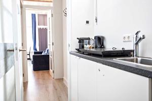 a kitchen with a sink and a counter top at Haarlem Square House City Centre Haarlem in Haarlem