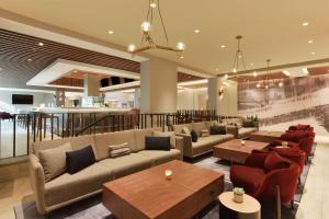 a lobby with couches and tables and a bar at Hyatt Centric Santa Clara Silicon Valley in Santa Clara