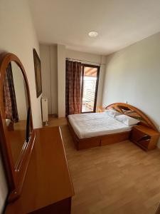 a bedroom with a bed and a large window at Filia Garden in Samos