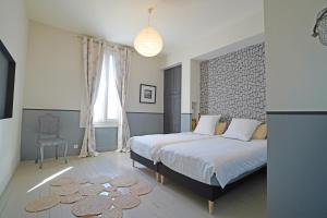 a bedroom with a king sized bed and a chair at Casa Bella in Saint-Georges-de-Didonne