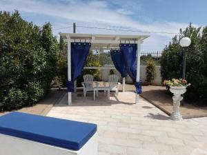 a patio with a gazebo and a table and chairs at Sole&Mare in Monopoli
