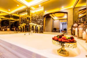a bathroom with a tub with a bowl of fruit in it at Andalouse Elegant Suite Hotel in Trabzon