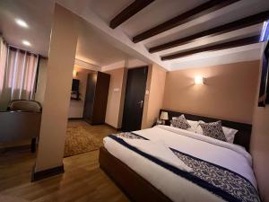 a bedroom with a large bed in a room at Hotel Garuda in Bhaktapur