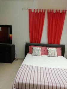 a bedroom with a bed with red curtains at Sole&Mare in Monopoli