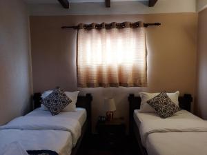 Postel nebo postele na pokoji v ubytování Hotel Garuda