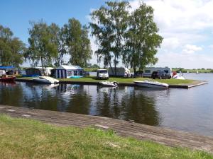 a group of boats parked on the water next to a lake at PURE - Chalet Zeeland - Air conditioning and washing machine in Hoek