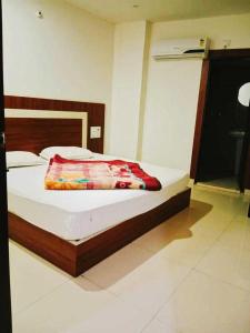 um quarto com uma cama com uma cabeceira de madeira em POP Hotel H5 em Kurukshetra