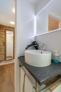 y baño con lavabo blanco y espejo. en Apartamento Qian porto Centro, en Oporto