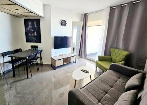 a living room with a couch and a table at GO to apartments in Leonardo in Bat Yam