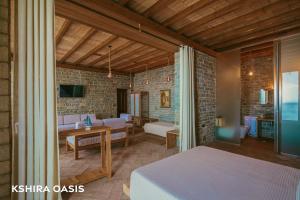 een slaapkamer met een bed en een woonkamer bij Kshira Oasis - Luxury 7-Bedroom Vila in Qeparo