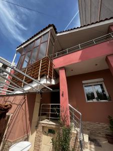 a house with a staircase in front of it at Retreat in the centre of Korce in Korçë