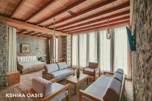 a living room with a couch and a table at Kshira Oasis - Luxury 7-Bedroom Vila in Qeparo