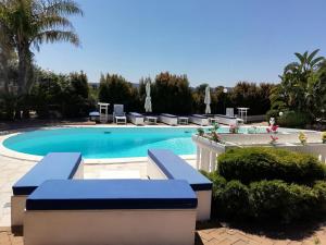 a swimming pool with blue water in a resort at Sole&Mare in Monopoli