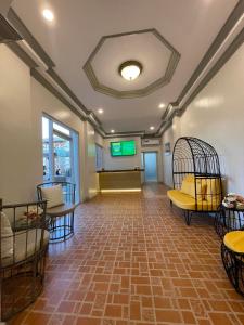 an empty waiting room with a bird cage in the middle at El Palacio Hotel & Resort in Cavite